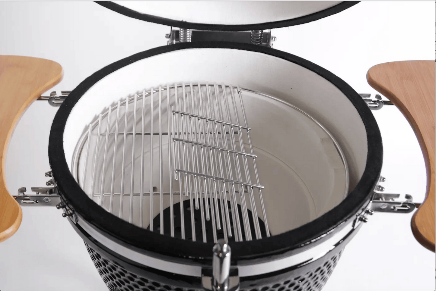 Top view of the Kokomo Grills 21-Inch Kamado Ceramic BBQ Grill KO-21-KAMADO, featuring a white interior, metal cooking grate, and wooden side shelves—ideal for Kamado grill enthusiasts and charcoal cooking.