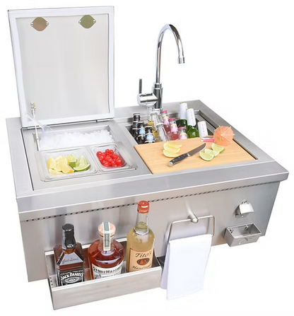 The Kokomo Grills 30” Built-In Bartender Cocktail Station includes a farmhouse sink, ice chest, bottle opener, garnish containers, cutting board with knife and garnishes, liquor shelves, and dispensers for towels and napkins—all stainless steel.