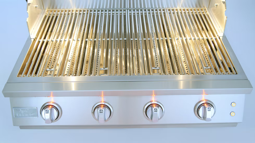 A close-up of the Kokomo Grills 32-Inch Elite Built-In Gas Grill (4 Burner) by Kokomo Grills, featuring four control knobs switched on and spotless, gleaming grill grates—ideal for any outdoor kitchen.