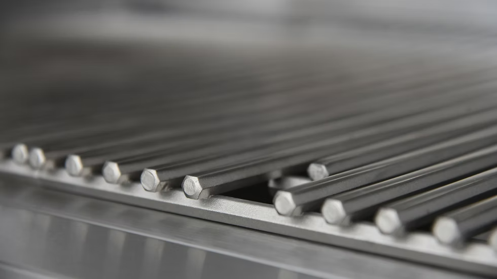 Close-up of metal rods with hexagonal ends, neatly stacked to complement your Kokomo Grills 32-Inch Elite Built-In Gas Grill (4 Burner) setup. Blurred background adds depth and highlights quality construction materials from Kokomo Grills.