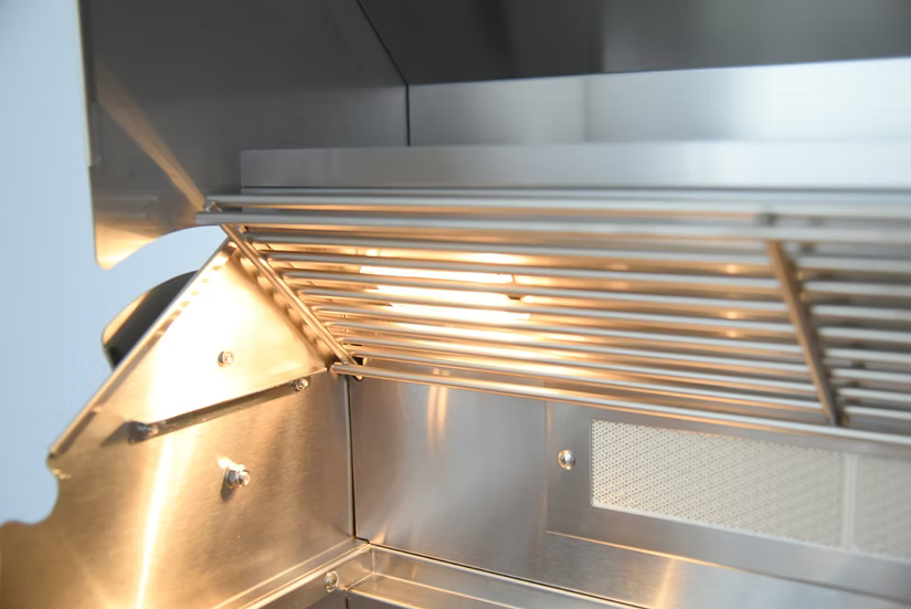 Close-up of a modern stainless steel range hood, ideal for an outdoor kitchen with the Kokomo Grills 32-Inch Professional Built-In Gas Grill (4 Burner). Features built-in light, metal grates, and mesh filter with a clean, reflective look.