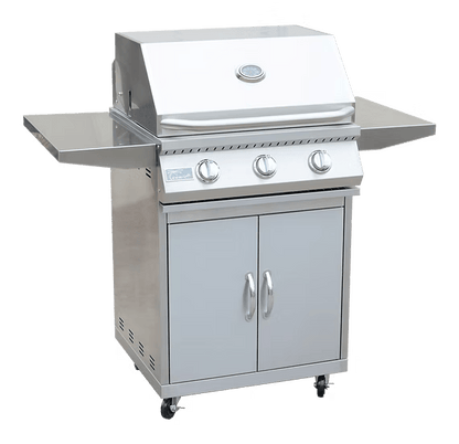The Kokomo Grills 3 Burner 26-Inch Cart Model BBQ Grill features a stainless steel body, three control knobs, two side shelves, a double-door lower cabinet, and locking casters—ideal for your outdoor kitchen. Shown on a plain white background.