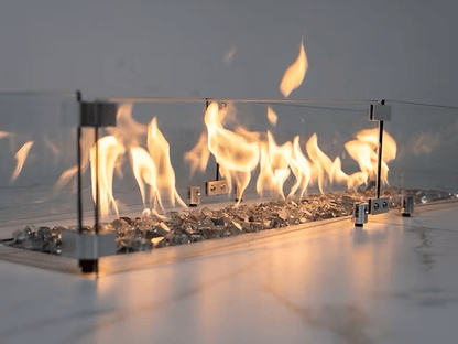 The Kokomo Grills Baja with Fire 7-Foot-6-Inch by 9-Foot Kitchen Island features a modern tabletop fireplace with decorative glass rocks and a sleek glass-metal frame, perfect for enhancing your BBQ or outdoor kitchen island.