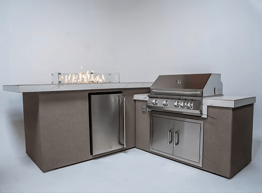 Contemporary outdoor kitchen featuring the Kokomo Grills Baja with Fire 7'6" x 9' Kitchen Island, complete with BBQ grill, refrigerator, storage cabinets, and a linear gas fire countertop by Kokomo Grills, set against a plain background.