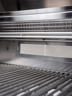 Close-up of the inside of the Kokomo Grills Baja with Fire 7’6” x 9’ Kitchen Island, featuring spotless stainless steel racks and a vented back panel—ideal for upgrading any BBQ Island or Outdoor Kitchen.
