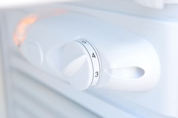 Close-up of the Temp Control dial, set to 4, on the Kokomo Grills Built-In Outdoor Kitchen Refrigerator with Soda Rack and Lights (KO-FRIDGE), showing numbered settings (3-5) and a vented, sleek design.