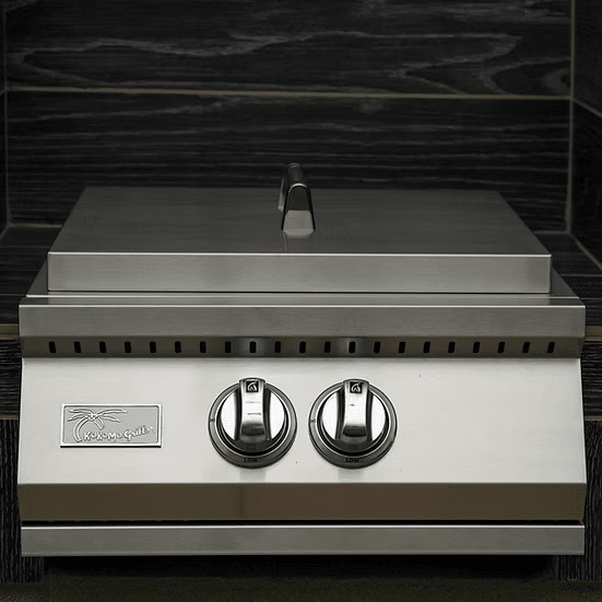 The Kokomo Grills Built-In Power Burner with Removable Grate for Wok features two control knobs, a closed lid, and the Kokomo Grills logo on front, ideal for any outdoor kitchen and set against a dark wooden background.