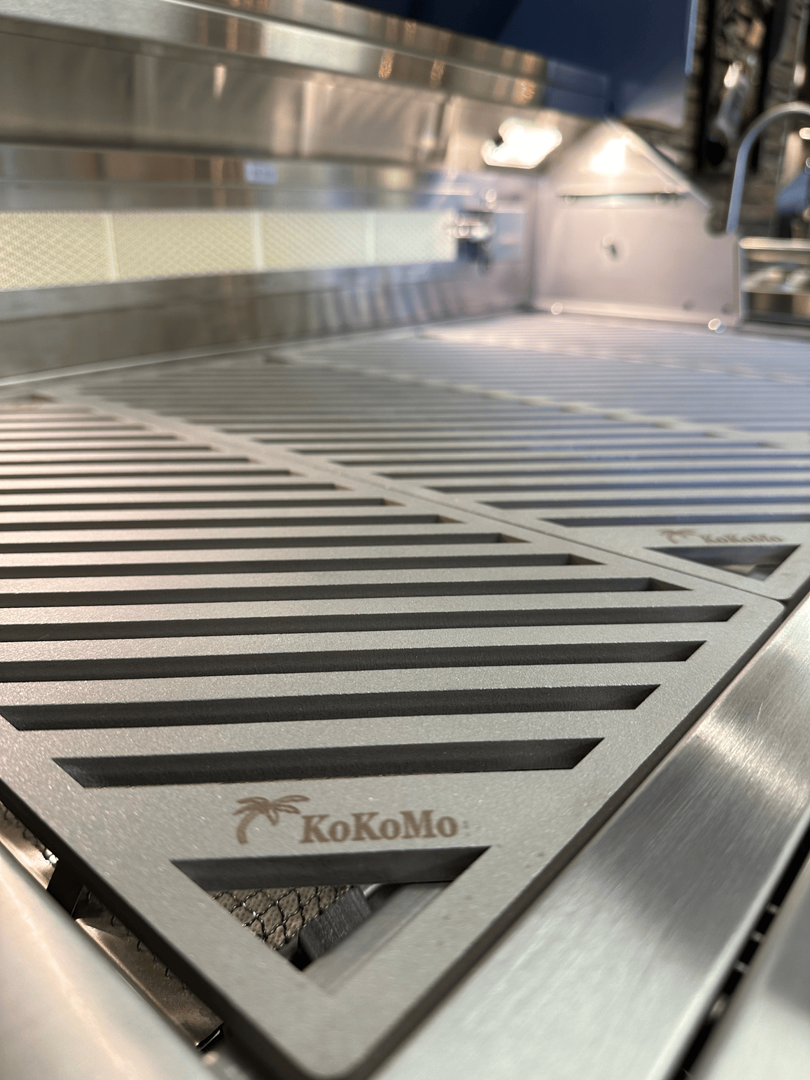 Close-up of Kokomo Grills LuxCut Laser-Cut Culinary Grates for 3, 4, 5 Burner Classic and Pro Grills. The engraved Kokomo Grills logo and precise laser-cut lines highlight their durable stainless steel and sleek, modern design.