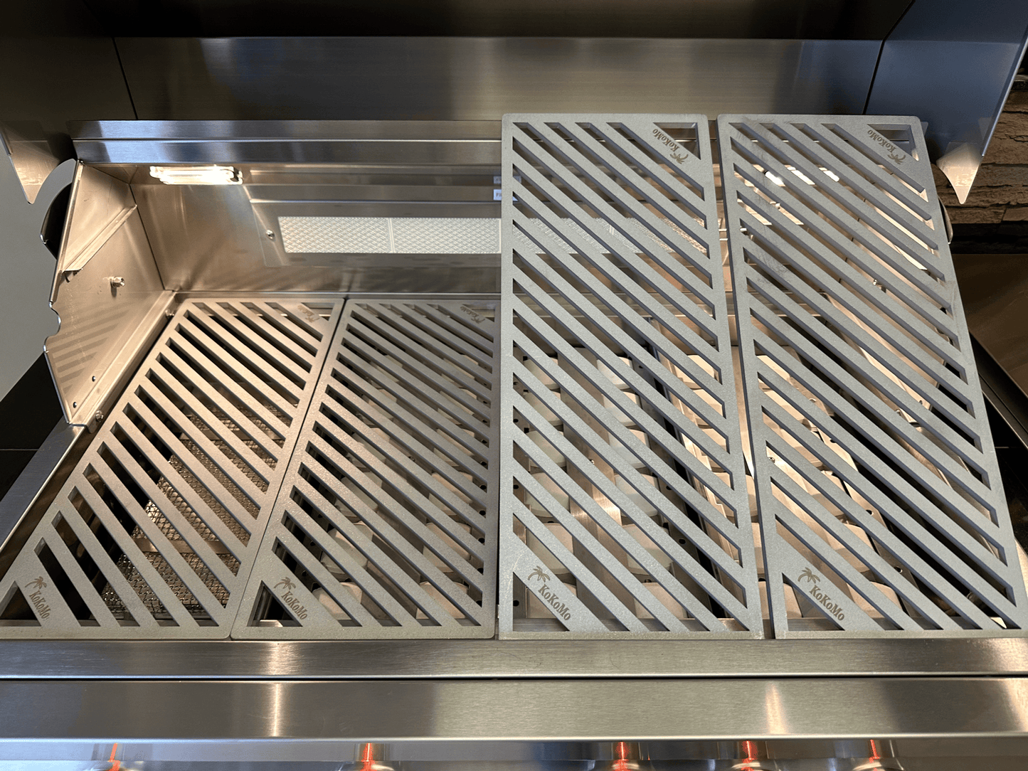 A close-up of Kokomo Grills LuxCut Laser-Cut Culinary Grates, designed for 3, 4, and 5 burner Classic and Pro grills, shows the clean, neatly arranged stainless steel grates by Kokomo Grills inside the outdoor grill.