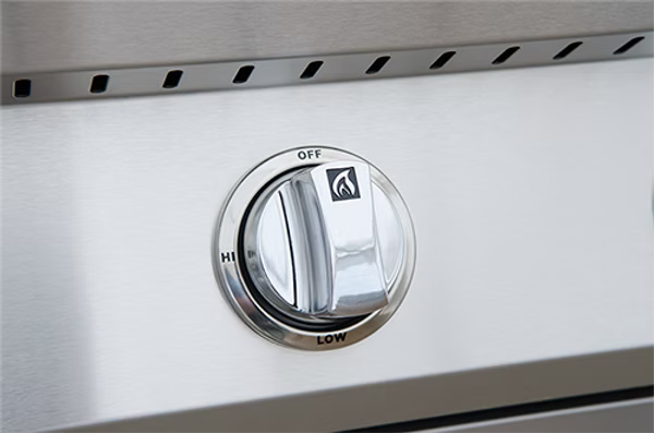 A close-up of a stainless steel control knob on the Kokomo Grills Professional Built-In Power Burner with LED Lights and Removable Grate for Wok, showing Off, High, and Low settings—ideal for any outdoor kitchen.