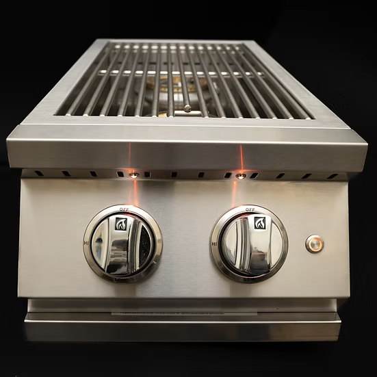 A close-up of the KoKoMo Grills Professional Double Side Burner with Removable Cover by Kokomo Grills, showcasing two control knobs and a metal grate, set against a black background.