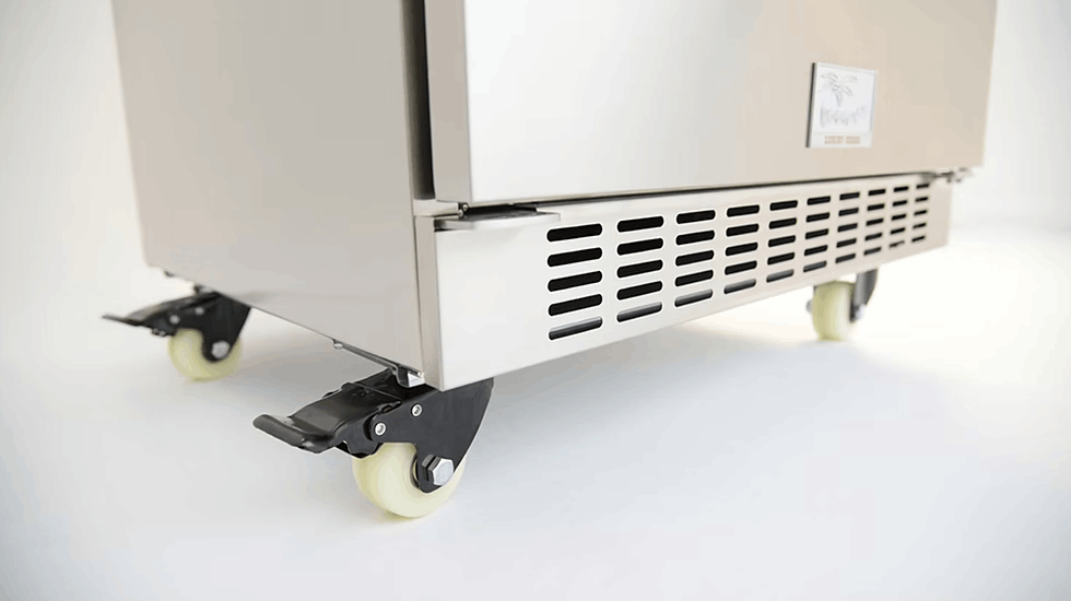 Close-up of the Kokomo Grills Professional Luxury Outdoor Kitchen Kegerator KO-LUX-KEG, crafted from 304 stainless steel with four caster wheels, ventilation slots, and a brake lever, set against a white background.