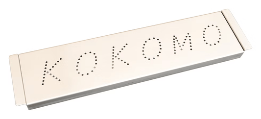 The Kokomo Grills Smoker Chip Box Insert in Stainless Steel (KO-BAK-SMKBX) is a rectangular smoker box perfect for adding smoky flavor to your gas BBQ. The lid features "KOKOMO" spelled out in holes for a stylish touch.