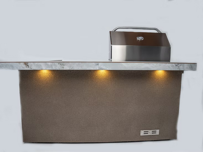 The Kokomo Grills St. John 7-Foot and 6-Inch Kitchen Island by Kokomo Grills features a stainless steel hood, a stone countertop, and three lights that highlight the textured brown base below the counter.