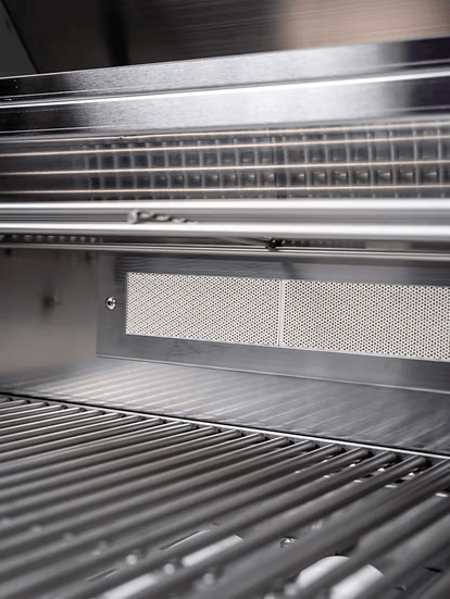 Close-up view of the interior of the Kokomo Grills St. John 7-Foot and 6-Inch Kitchen Island by Kokomo Grills, highlighting its clean metal racks, vent, and sleek stainless steel surfaces.