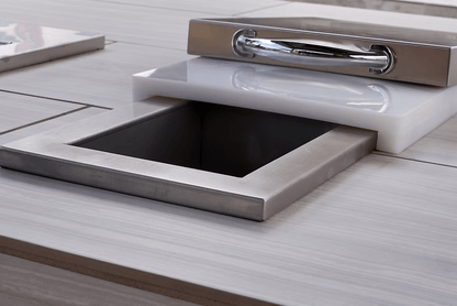 The Kokomo Grills Trash Chute and Cutting Board KO-TRSCH by Kokomo Grills is built into a tiled countertop, featuring a modern square design with a shiny lid—ideal for any outdoor kitchen.