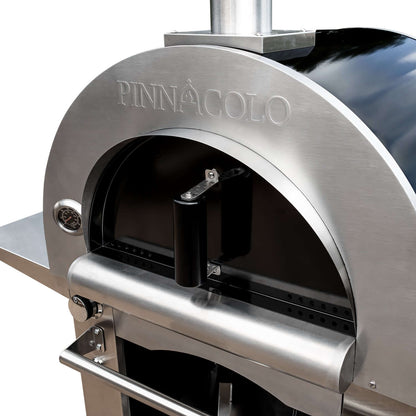 Close-up view of the PINNACOLO IBRIDO (Hybrid) Wood/Gas Outdoor Pizza Oven, with the door closed and "PINNACOLO" logo etched on the upper dome.