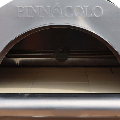 Close-up of a Fire One Up PINNACOLO IBRIDO outdoor pizza oven entrance, showcasing the brand name engraved on the metal arch above the open cooking interior.