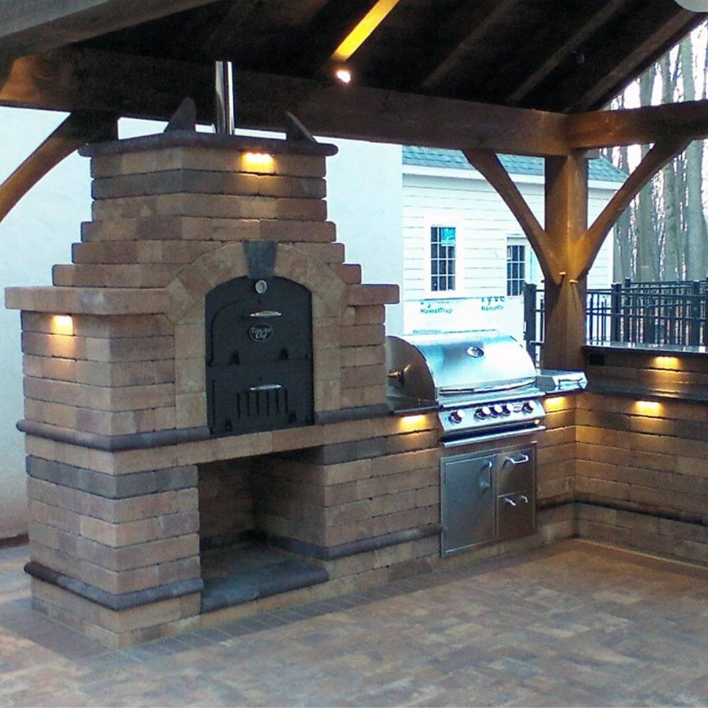 Tuscan Chef Medium Built-In Deluxe Family Pizza Oven (Model GX-CM) – Installed in a brick enclosure shared with a BBQ grill, under a grill gazebo.